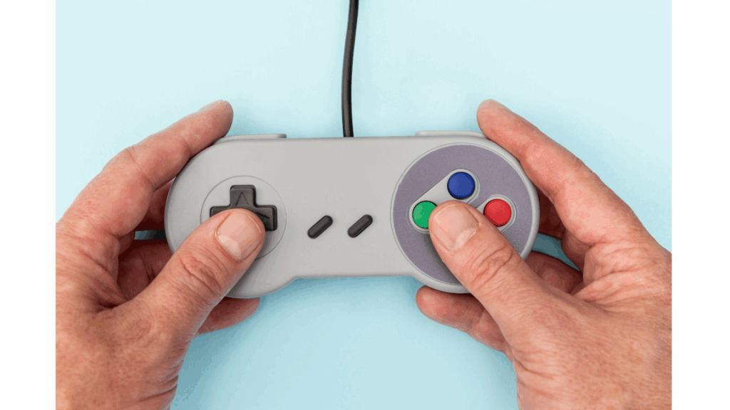 Famicon controller being pressed by two thumbs.